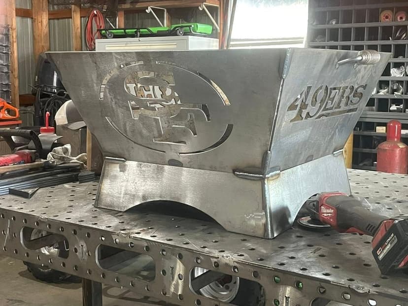 Metal scoreboard featuring San Francisco 49ers logo in a workshop setting.